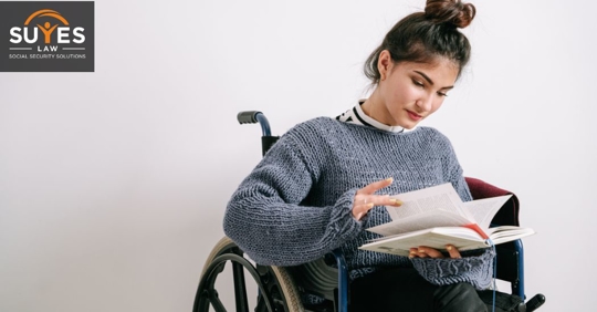 disabled person looking at notes and documents